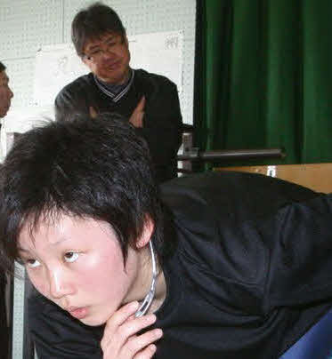 10年、練習中の高木美の動きを見守る東出氏（奥）