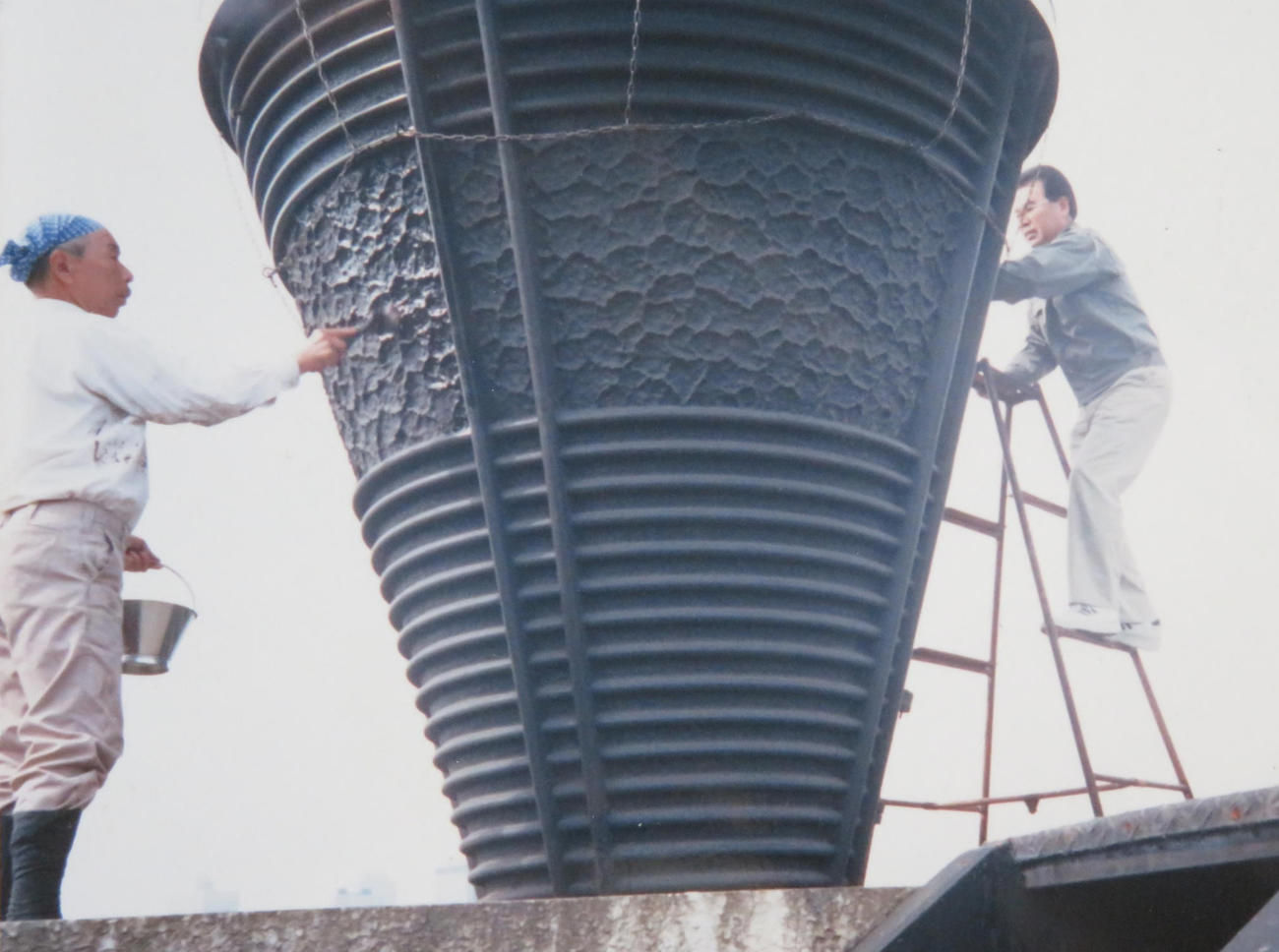 89年10月10日、旧国立競技場でごま油磨きをする鈴木文吾さん（左）と鈴木昭重さん