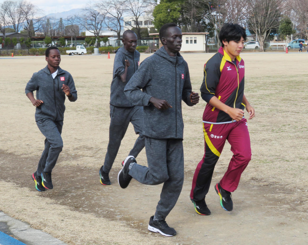 1月15日、19年日本選手権400メートル2位の小渕瑞樹氏（右）とともに練習する南スーダン選手団