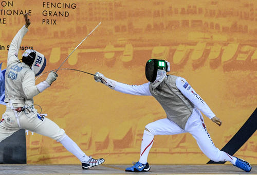 3月、GPドーハ大会の準決勝でエディリ（左）から得点する敷根崇裕。ポイントが決まってマスクの緑LEDが点灯した（C）日本フェンシング協会