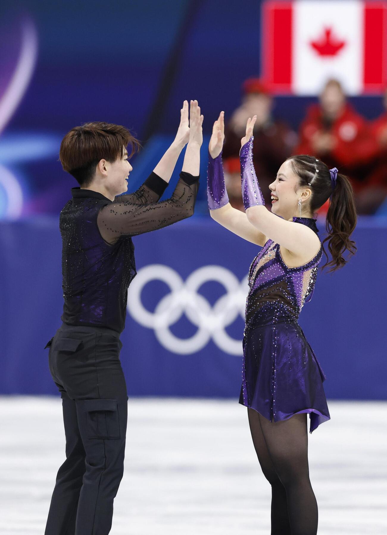 団体アイスダンス・RDの演技を終え、タッチを交わす吉田唄菜（右）、森田真沙也組＝ミラノ（共同）