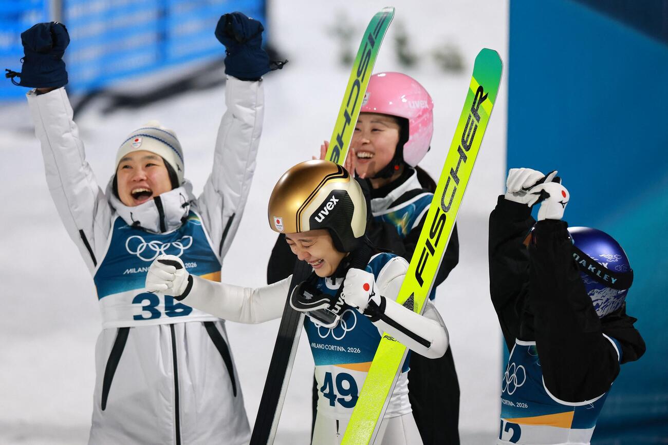 スキージャンプ女子ノーマルヒルで銅メダルを獲得した丸山希(中央)は両手で渾身のガッツポーズを見せる(ロイター)