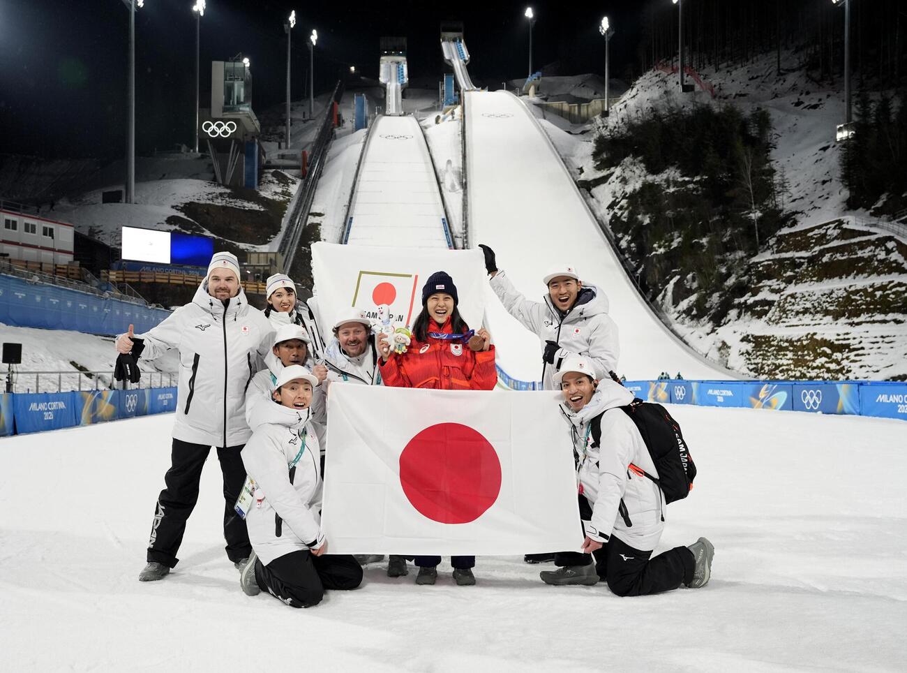 女子個人ノーマルヒルで銅メダルを獲得し、チームスタッフらと喜ぶ丸山希（右から3人目）（共同）
