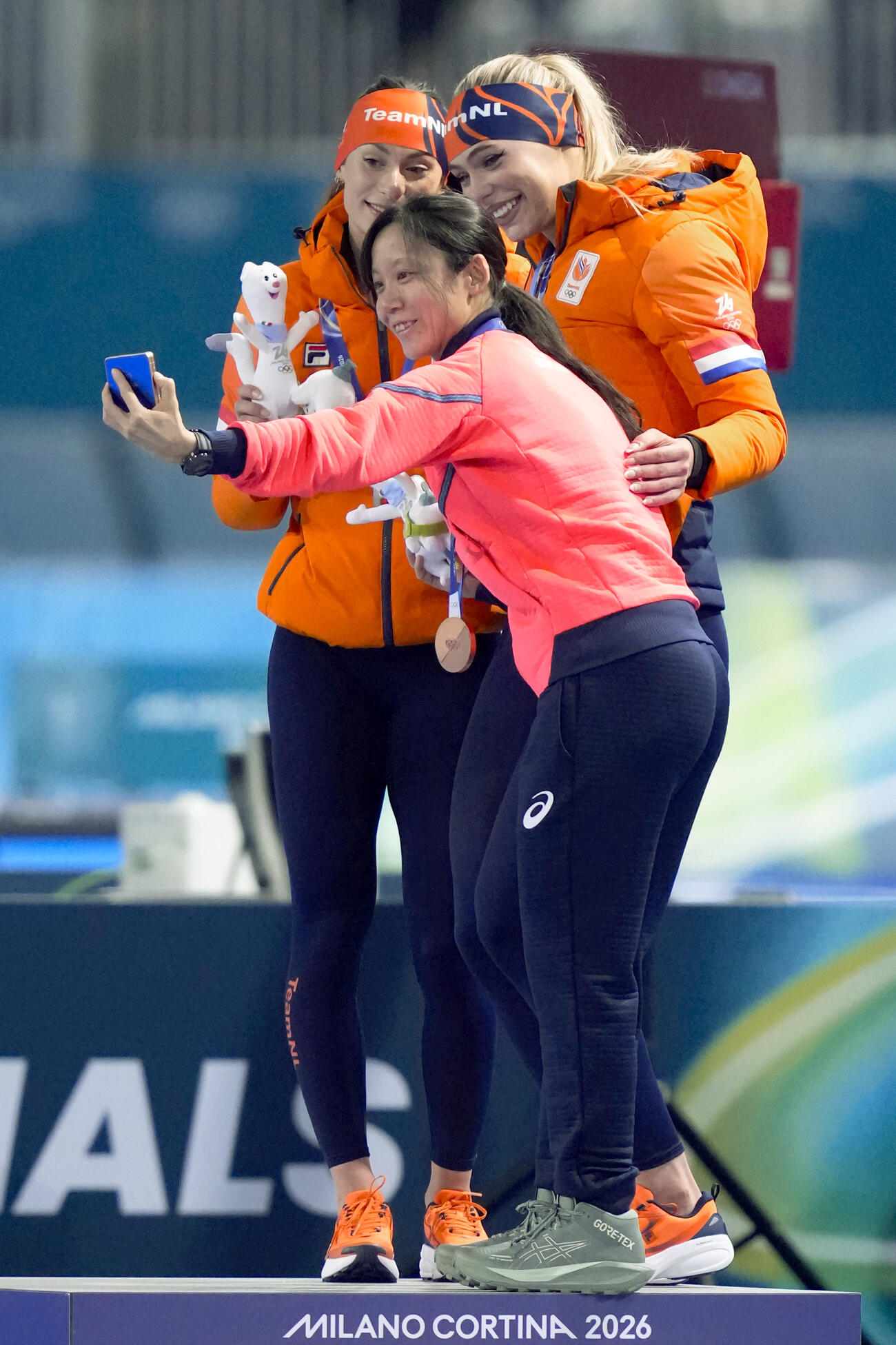 女子1000メートルで2位のフェムケ・コク（奥左）、優勝したユタ・レールダム（同右）と自撮りする3位の高木美帆＝ミラノ（共同）