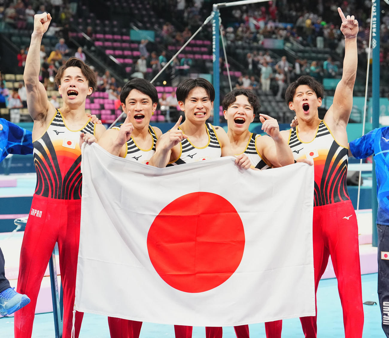 体操男子団体決勝、金メダルを決め日の丸を手に喜びを爆発させる日本の選手たち。左から杉野、谷川、萱、岡、橋本（撮影・垰建太）