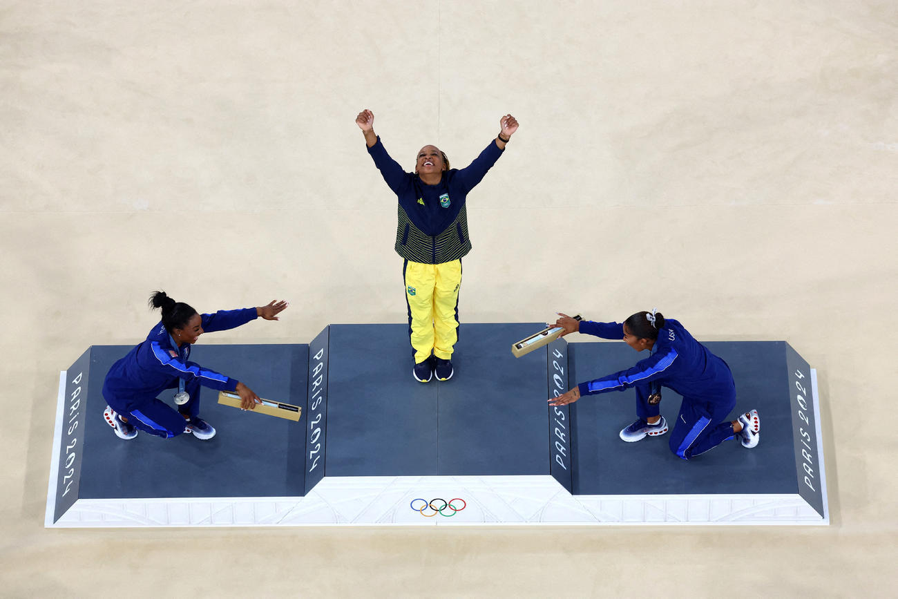 体操女子種目別床運動　表彰式で銀メダルのシモーヌ・バイルズ、銅メダルのジョーダン・チャイルズ（ともに米国）に祝福される金メダルのレベカ・アンドラデ（ブラジル）（ロイター）