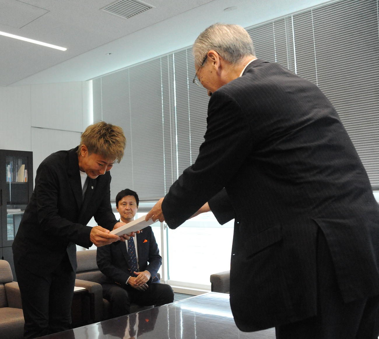 新発田市の二階堂市長（右）から菅谷不動尊の護摩札を受け取る平尾