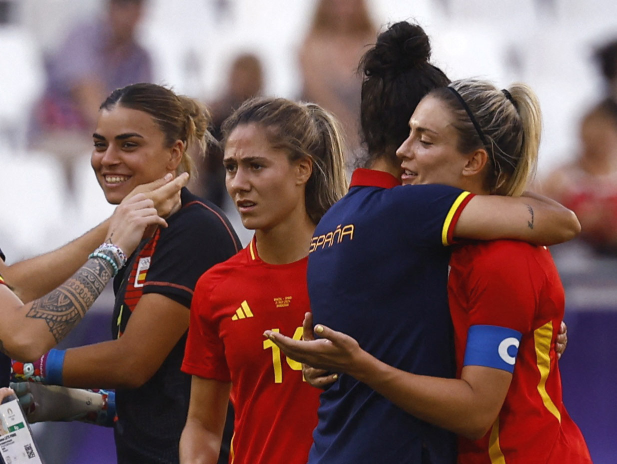 スペイン－ブラジル　試合後に監督と抱き合う選手たち（ロイター）