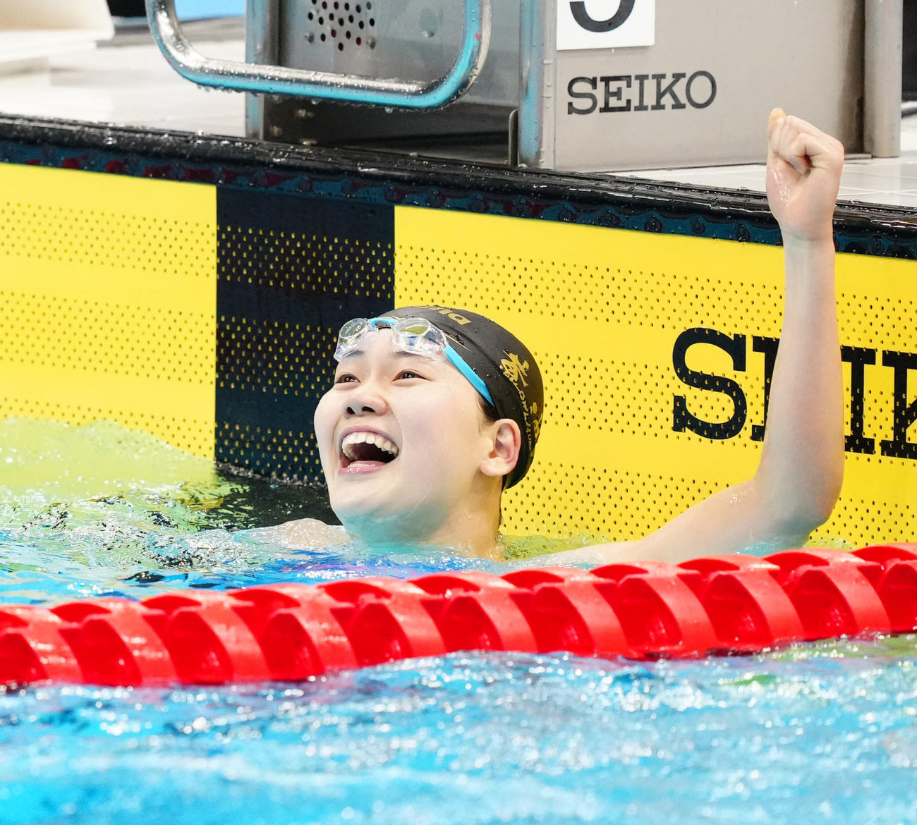 3月、パリ五輪代表選考会の女子100メートルバタフライ決勝で派遣標準記録に届き、笑顔を見せる平井
