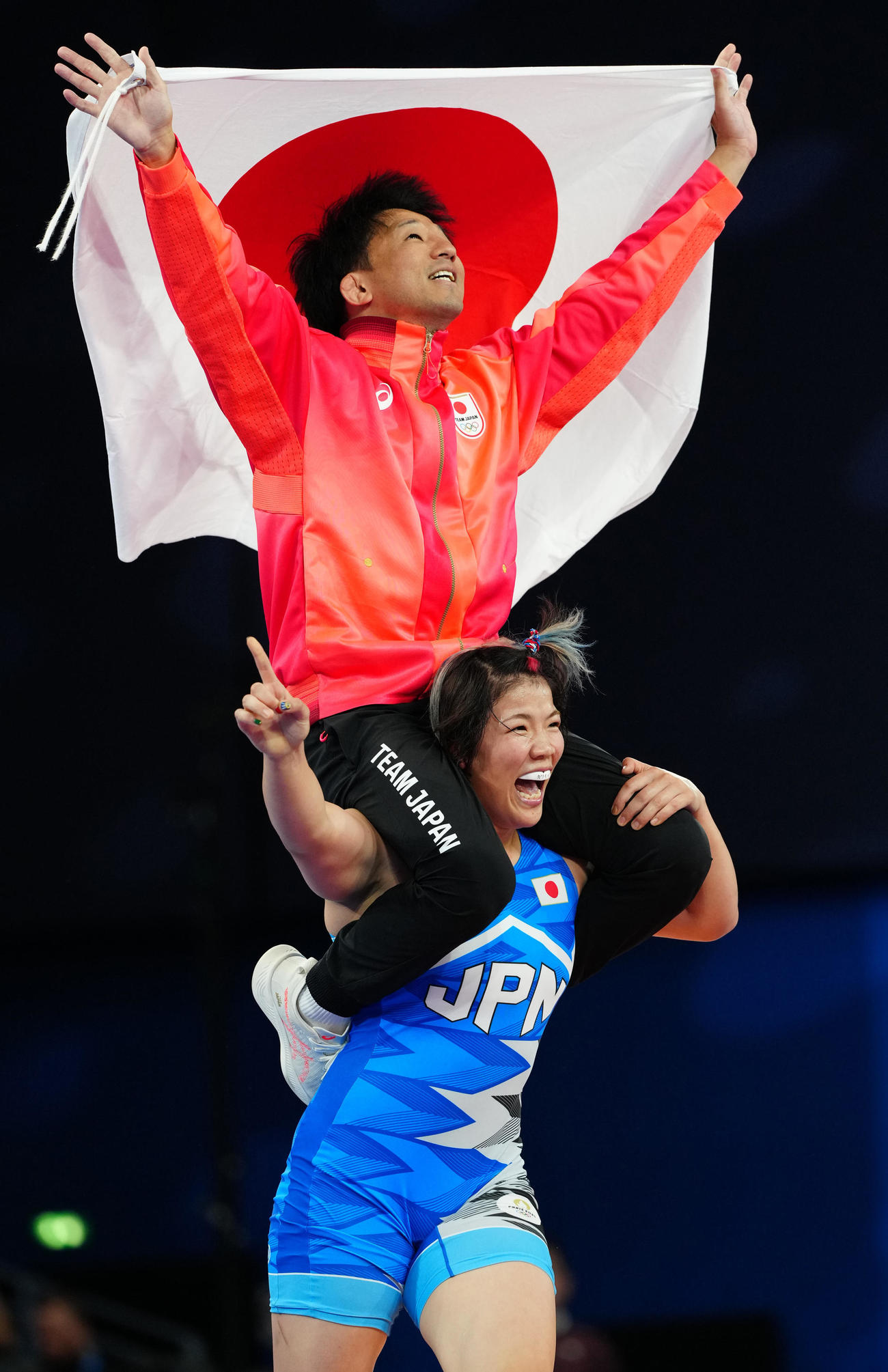 女子76キロ級決勝で優勝し前田コーチ（上）を肩車する鏡（撮影・江口和貴）