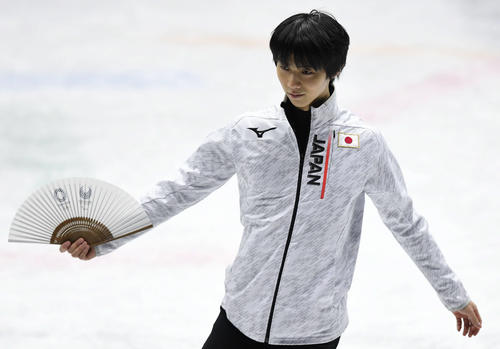 エキシビションの練習中に羽生結弦は東京五輪・パラリンピックのロゴがプリントされた扇子を手にする（撮影・山崎安昭）