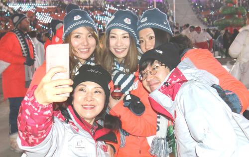 平昌五輪の閉会式でボランティアと記念撮影に納まる、左から広野、藤森、今井（撮影・河野匠）