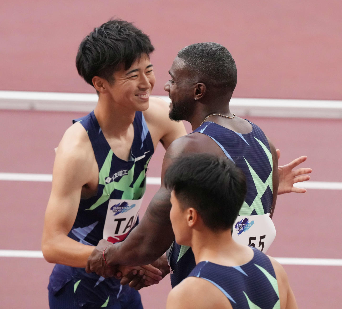 男子100メートル予選を終え、健闘をたたえ合うガトリン（右）と多田（撮影・鈴木みどり）