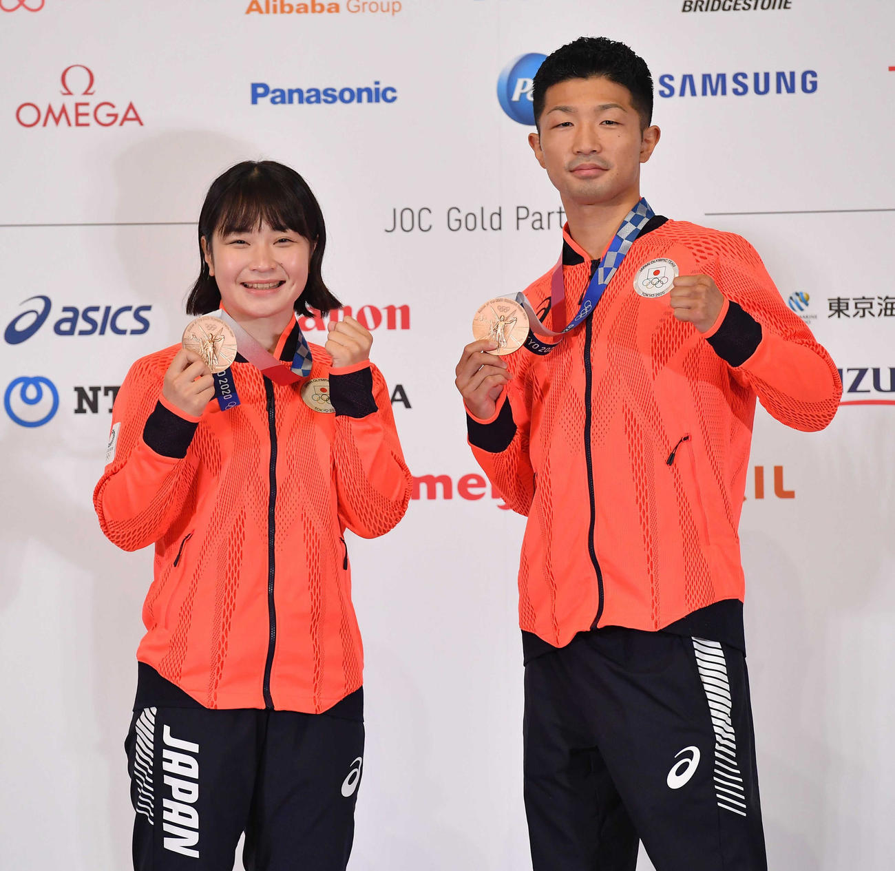 一夜明け会見を終え、メダルを手にポーズを決める並木（左）と田中（代表撮影）