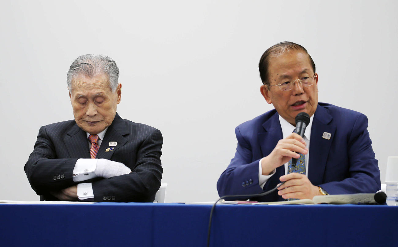 3月24日、東京五輪・パラリンピックの延期会見に臨む同組織委員会の武藤事務総長（右）と森会長