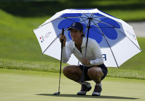 第2日、傘をさしながらラインを読むフランス代表セリーヌ・ブティエ（AP）