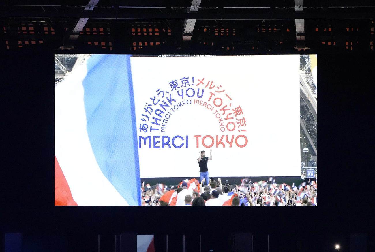閉会式の大型ビジョンに映し出されるフランス国旗とメッセージ（撮影・鈴木みどり）