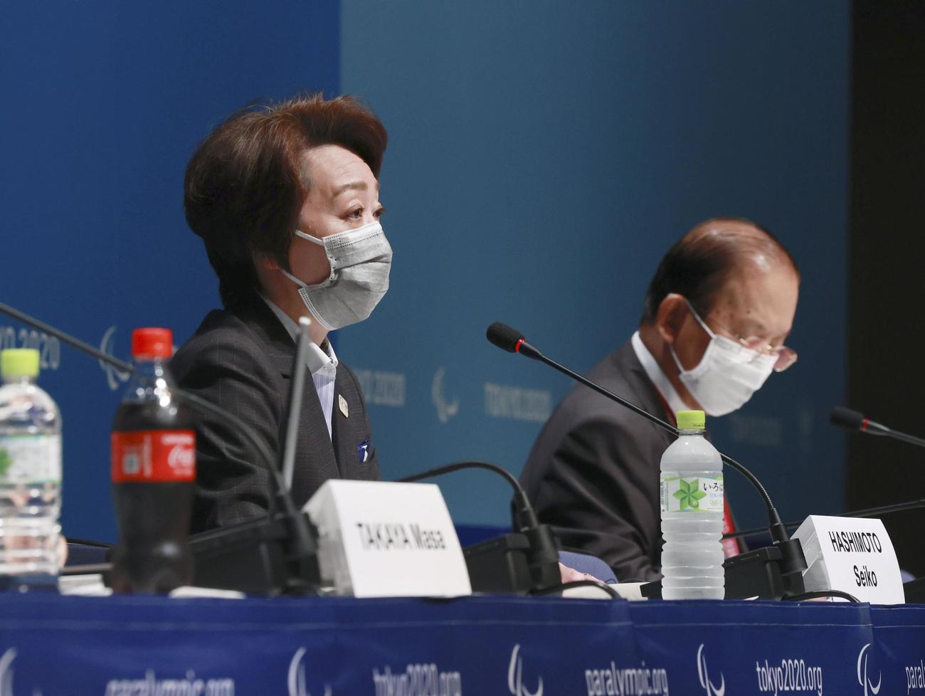 記者会見する東京五輪・パラリンピック組織委の橋本聖子会長。右は武藤敏郎事務総長（共同）