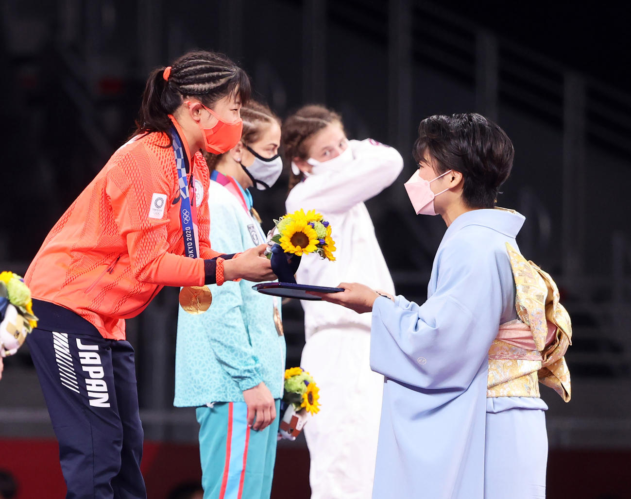 女子フリースタイル50キロ級の表彰式でプレゼンターの伊調さん（右）から花束を受け取る須崎（撮影・パオロ・ヌッチ）
