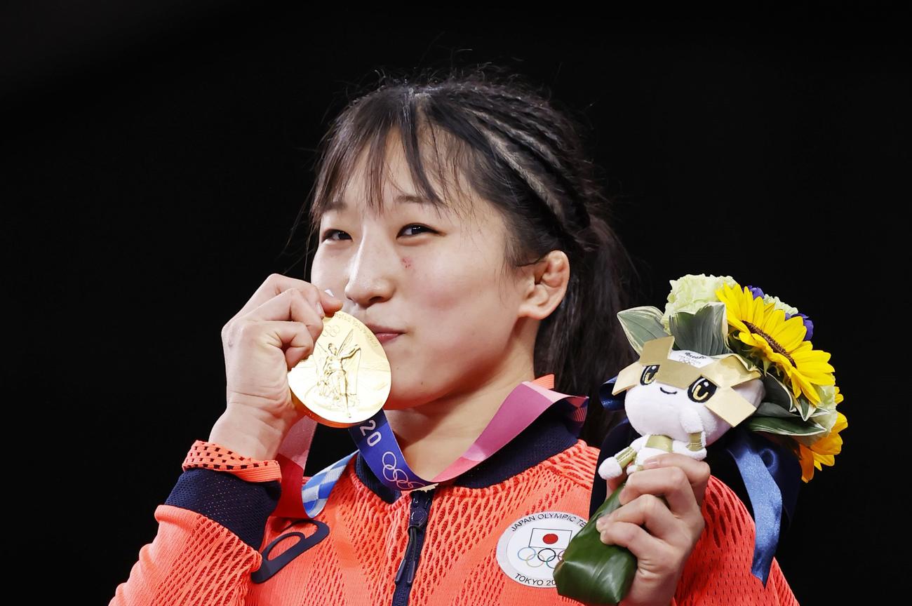 女子50 キロ 級で優勝し、笑顔で金メダルを手にする須崎優衣＝幕張メッセ（共同）