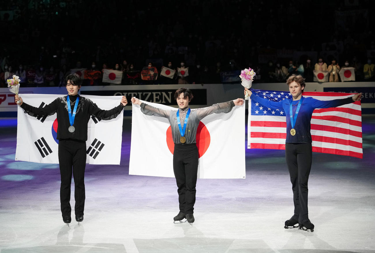 国旗を背に笑顔を見せる宇野。左は2位の車俊煥、右は3位のイリア・マリニン（撮影・横山健太）
