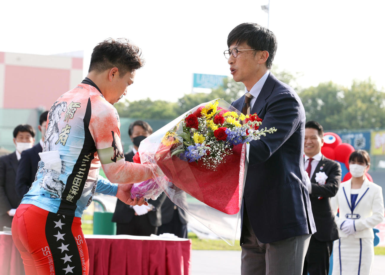 高松宮記念杯を制した古性優作（左）はプレゼンターの阪神前監督矢野燿大氏から花束を受け取る（撮影・上山淳一）