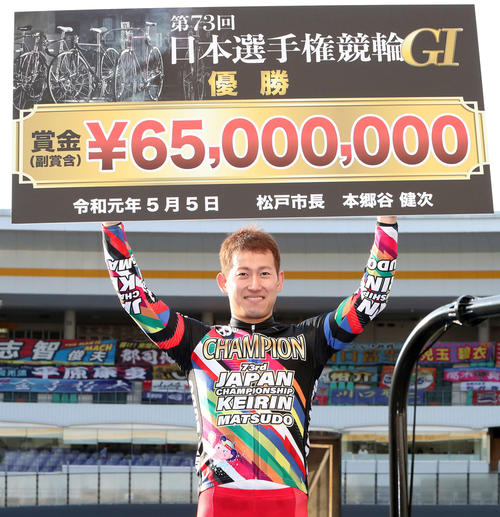 日本選手権34大会ぶり、通算7人目の完全Vを飾り、笑顔で賞金ボードを掲げる脇本雄太