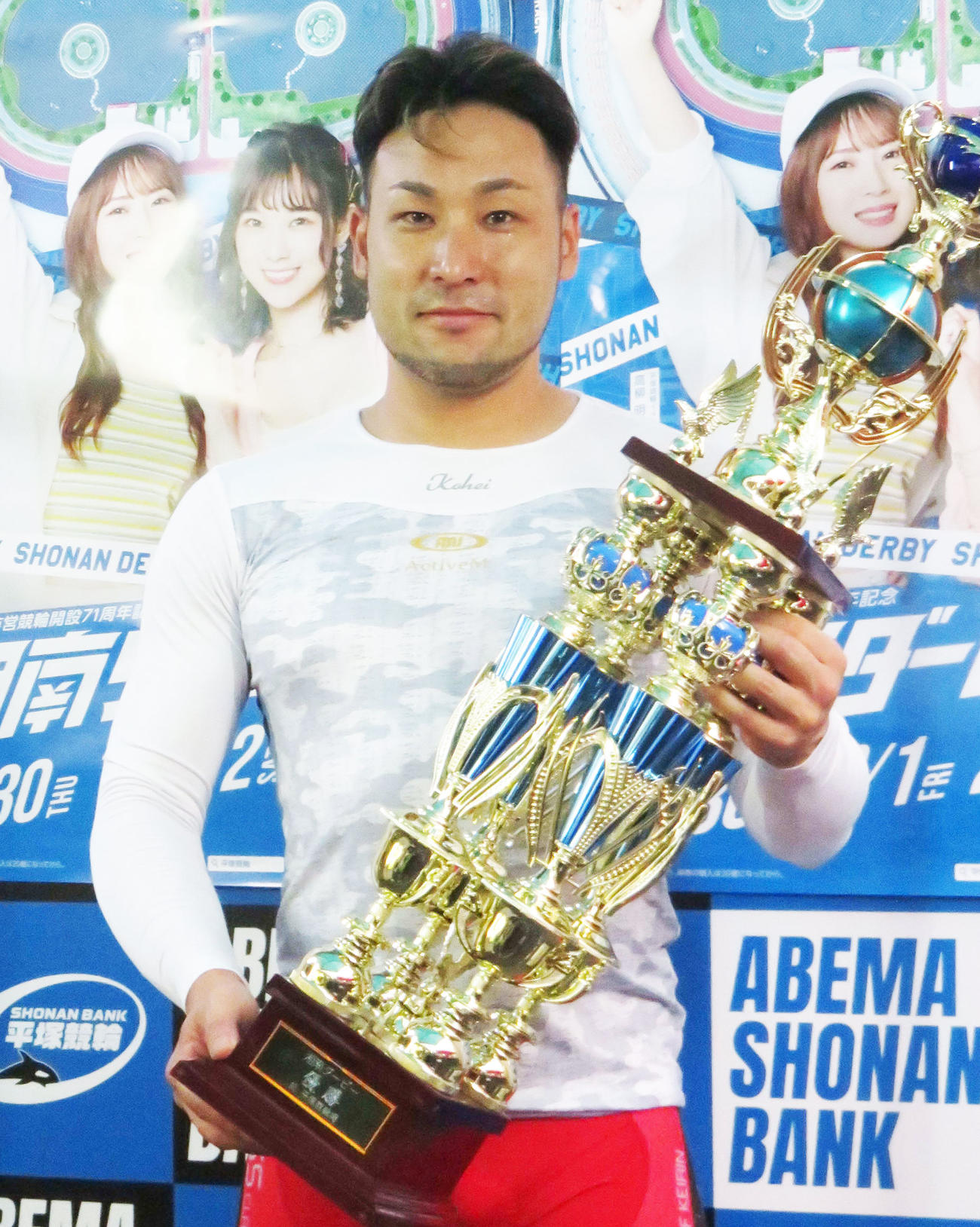 優勝トロフィーを手にする郡司浩平