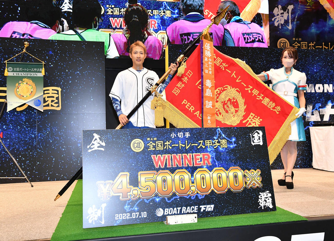 優勝旗を手に笑顔を見せる深谷知博（撮影・岩下翔太）