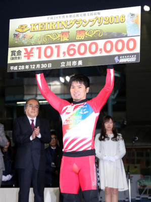 立川で2度目のKEIRINグランプリ制覇を果たし、賞金ボードを手に笑顔の村上義弘(2016年12月30日撮影)