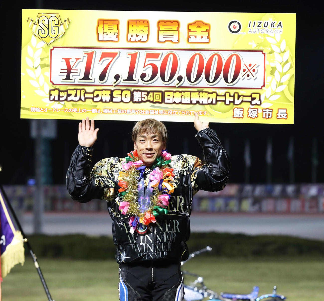 優勝戦を制し、笑顔でボードを掲げる青山周平（撮影・屋方直哉）