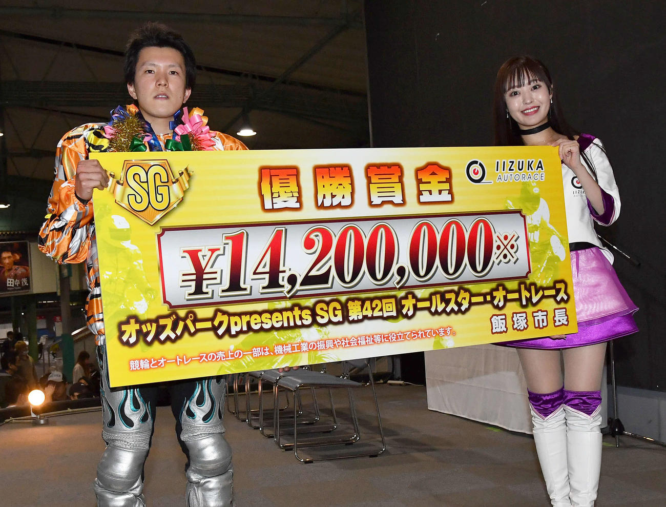 SGオールスターオートレース最終日　表彰式で飯塚オート5代目勝利の女神RUKA（右）と賞金ボードを掲げる鈴木圭一郎（撮影・岩下翔太）