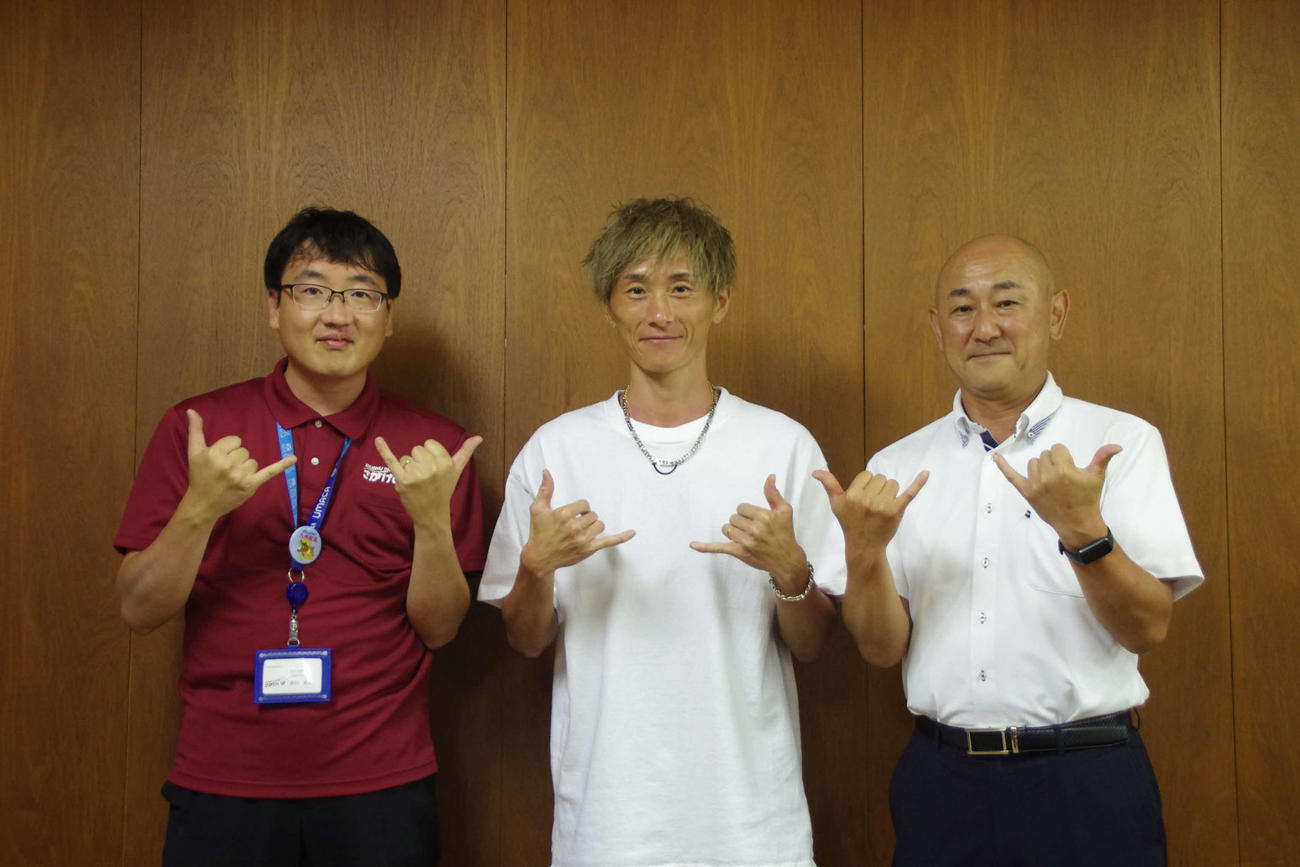 アロハポーズを決める峰竜太（中央）とびわこボート天川マネジャー（右）。左は佐賀競馬飯田健史広報販促係長