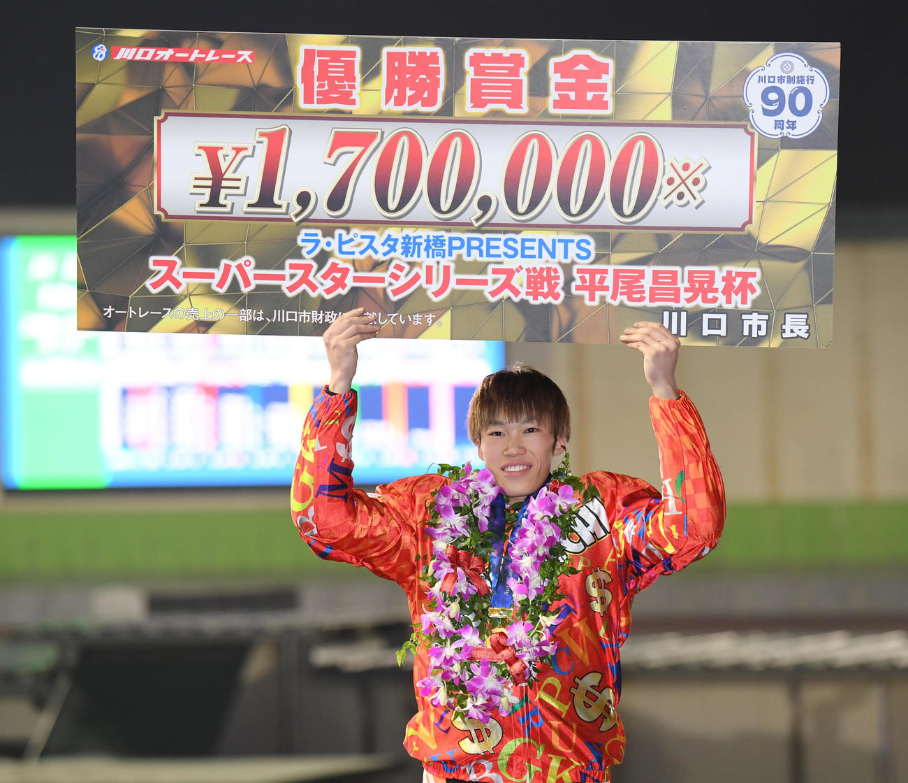 シリーズ戦で優勝した佐藤励は賞金ボードを掲げる（撮影・柴田隆二）