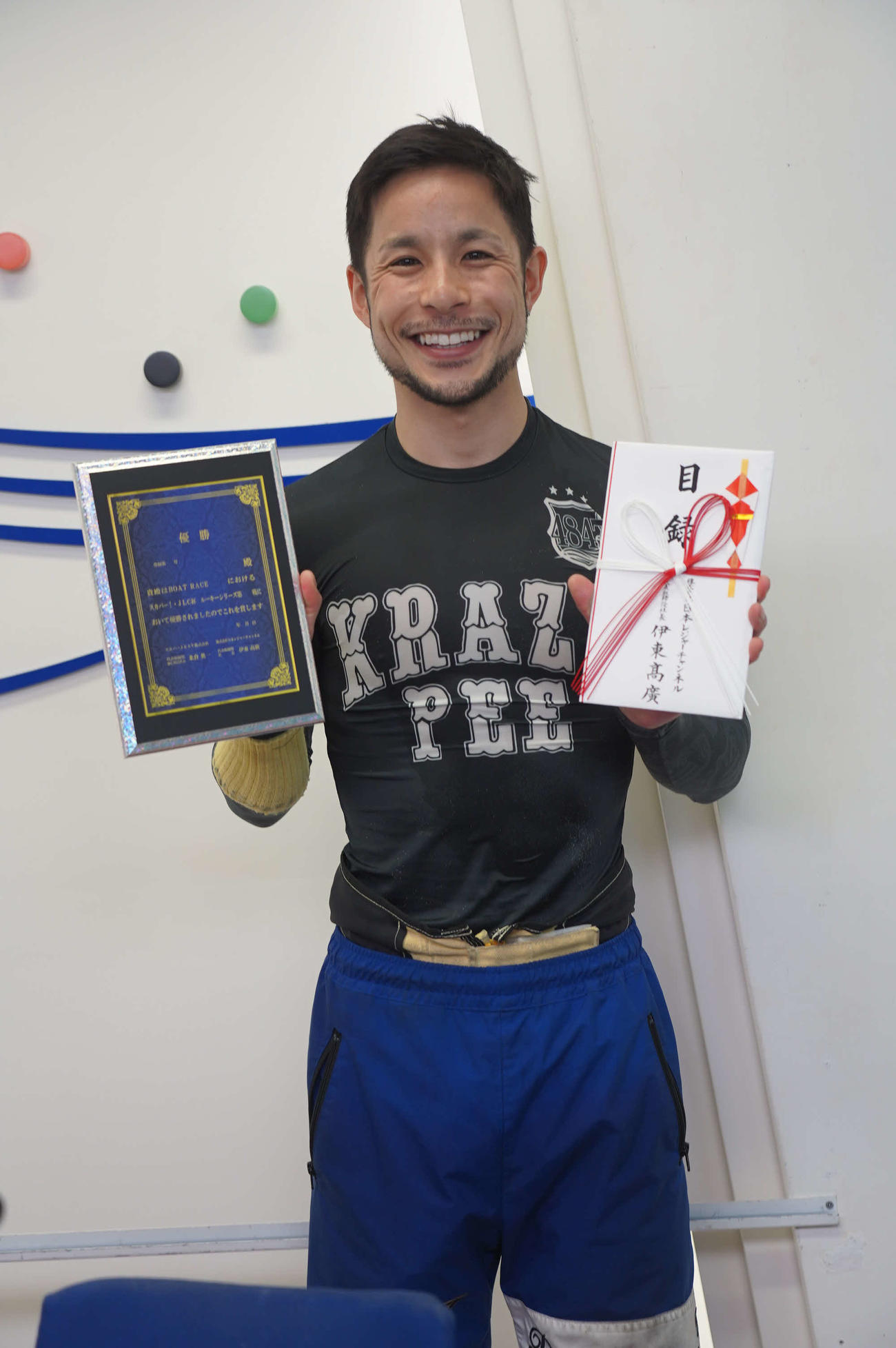 佐藤隆太郎が優勝し、記念盾と目録を手に笑顔