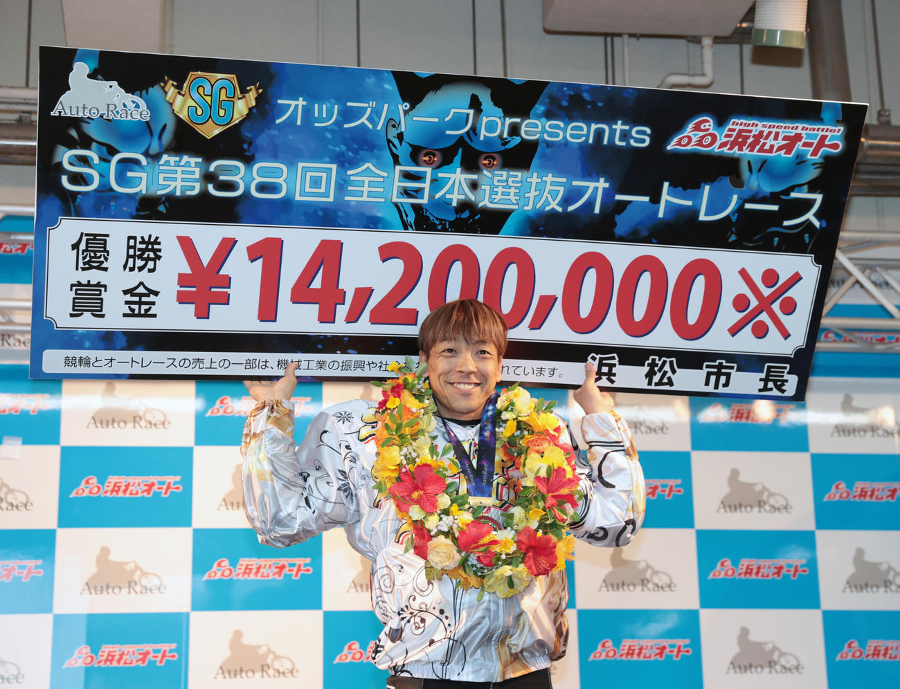 優勝した青山周平は賞金ボードを掲げる（撮影・柴田隆二）