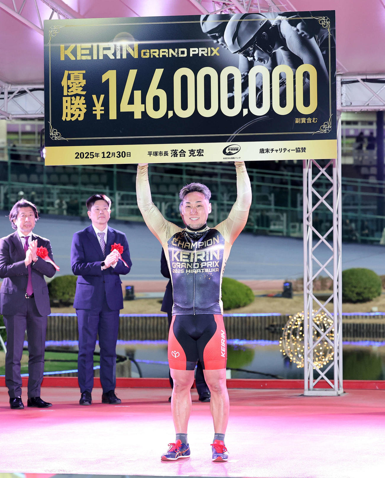 賞金ボードを手に笑顔を見せる郡司（撮影・鈴木正人）