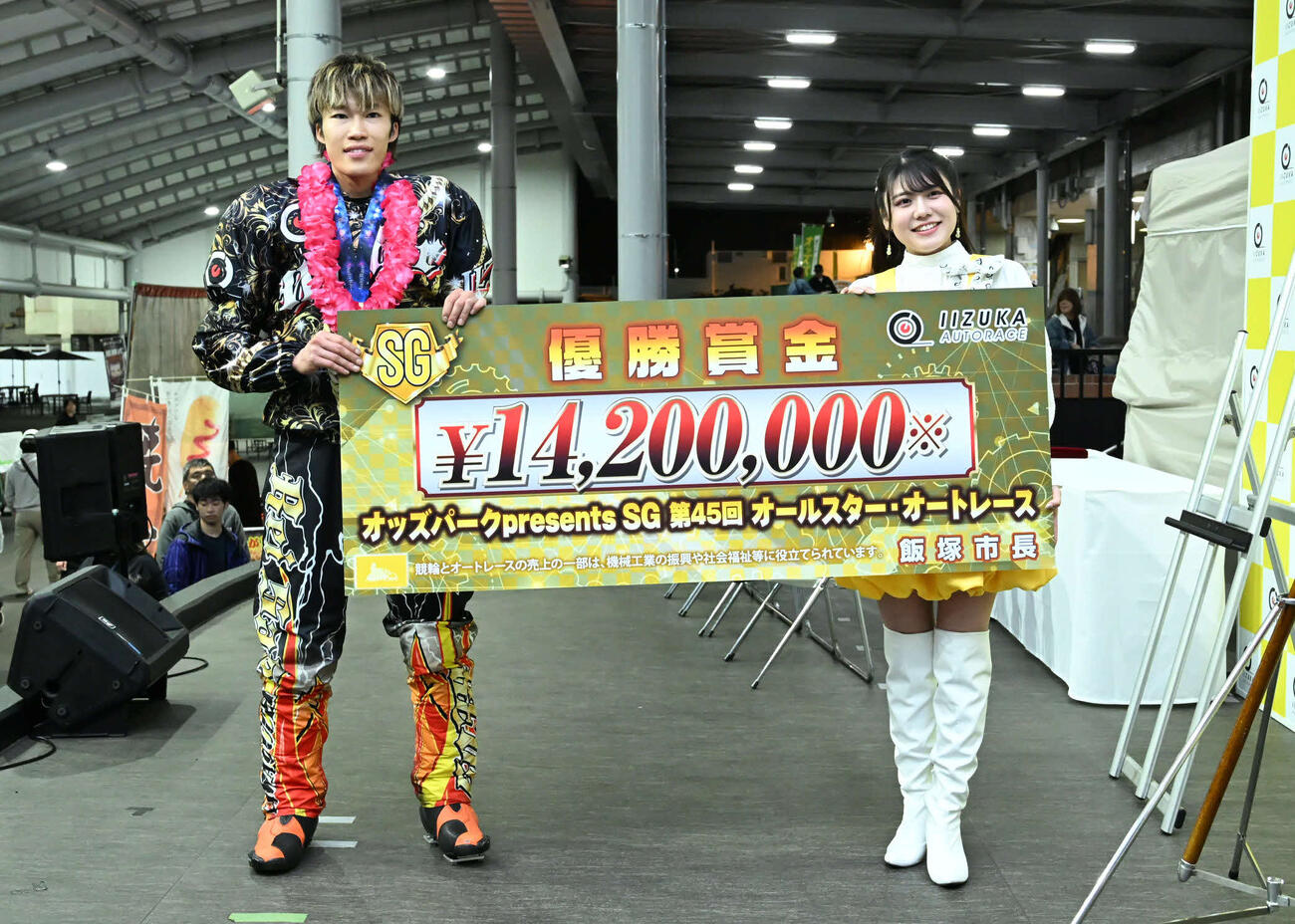 優勝賞金ボードを手に記念撮影に応じる佐藤励（左）（撮影・林敢治）＝飯塚オートレース場