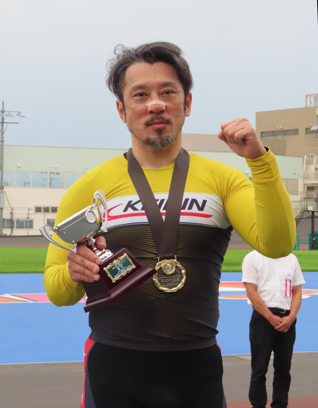 優勝カップを手にガッツポーズする和田健太郎
