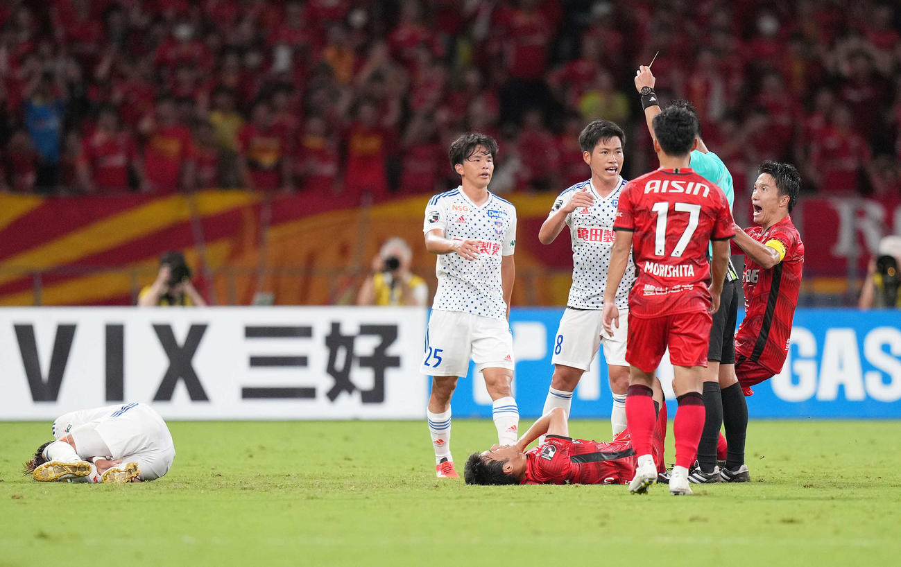 5日の名古屋戦後半、新潟鈴木（左端）を倒した名古屋米本（右）を押した新潟高（右から4人目）はイエローカードを受ける（撮影・菅敏）