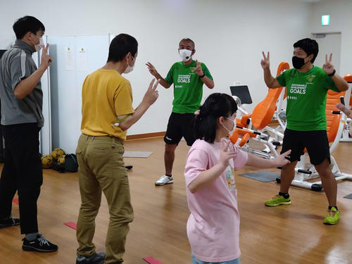 参加者とともに「えびかにダンス」を踊る「イケメンコーチ」こと中村氏（中央）と「ムーチョコーチ」こと武藤氏（右端）