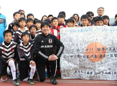 長崎の子どもたちから贈呈された応援フラッグと記念撮影に納まる森保監督（前列左から3人目）（撮影・河野匠）