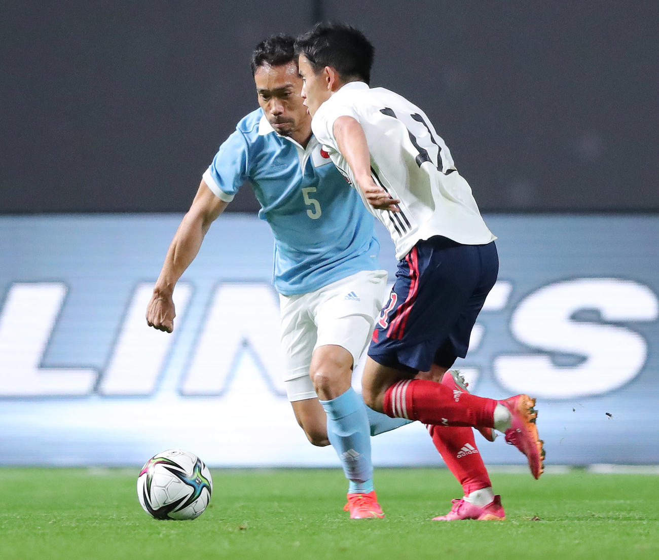 日本代表対U－24日本代表　前半、ドリブルで仕掛けるU－24の久保（手前）とプレスをかける日本の長友（撮影・垰建太）