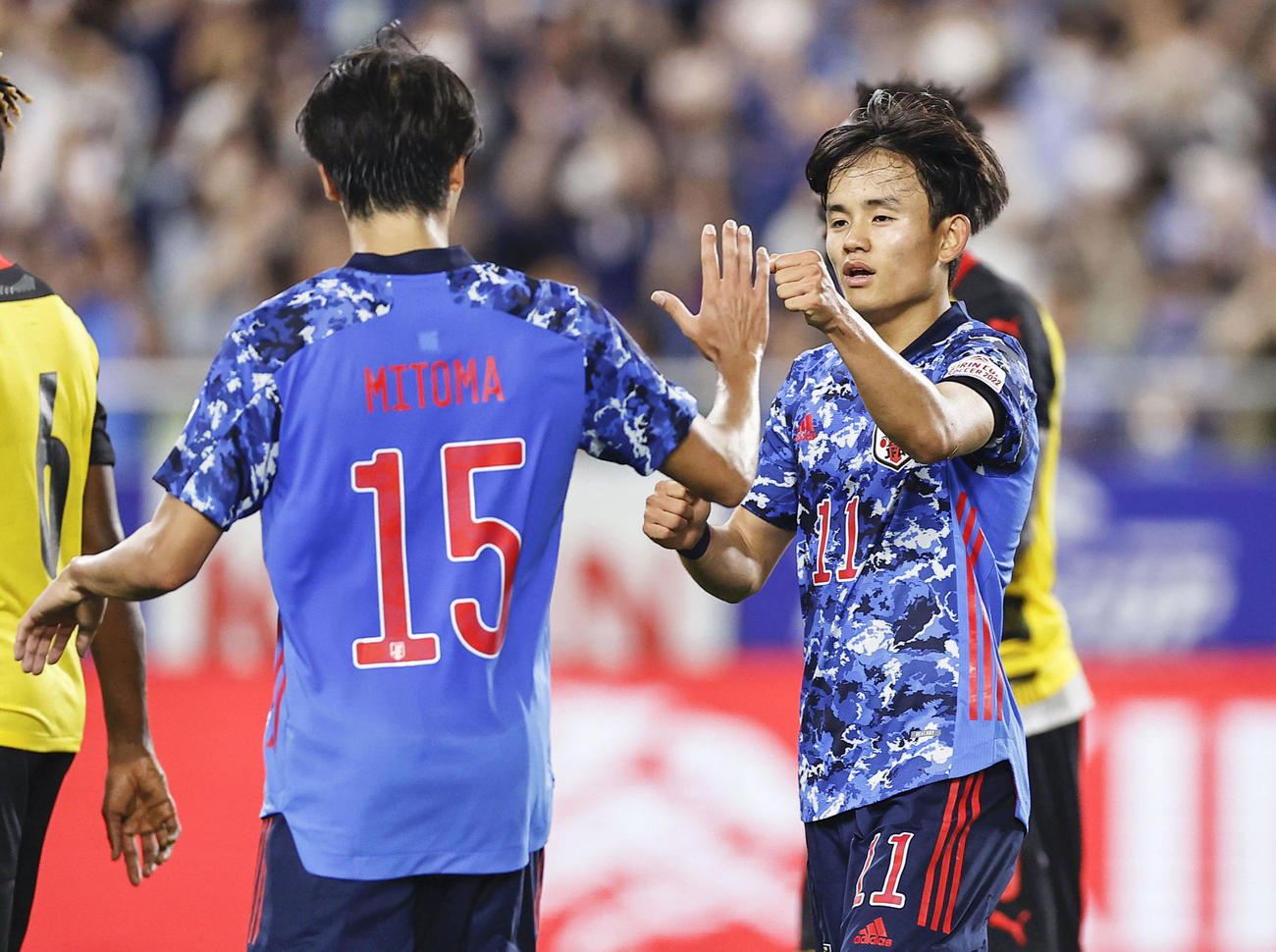 日本対ガーナ　後半、チーム3点目のゴールを決め、三笘（左）とタッチを交わす久保建英（共同）