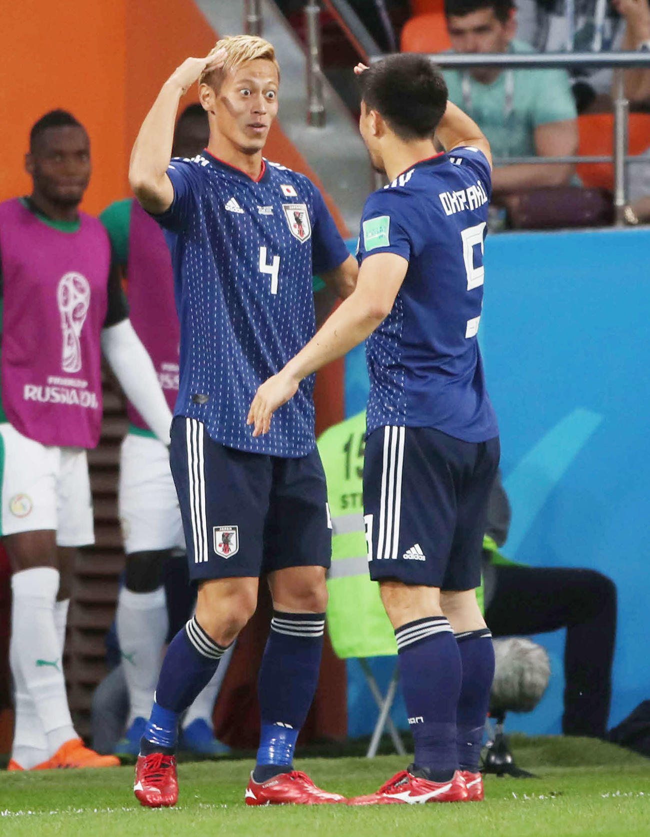 18年6月、W杯ロシア大会1次リーグのセネガルの後半、同点ゴールを決めた本田（左）は岡崎と敬礼ポーズする