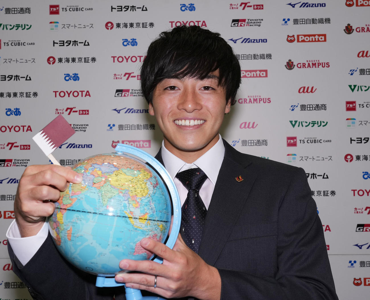 カタールを指さした地球儀を手に笑顔を見せる名古屋相馬（撮影・森本幸一）