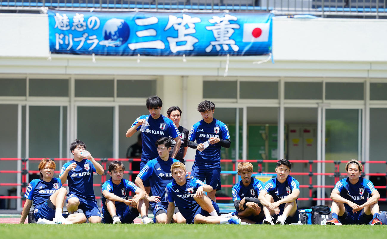 軽めの調整を終え別調整の選手たちの練習を見つめる堂安（中央）ら選手たち。左から板倉、相馬、久保、三笘、谷口、1人おいて、旗手、守田、菅原、中村敬（撮影・垰建太）