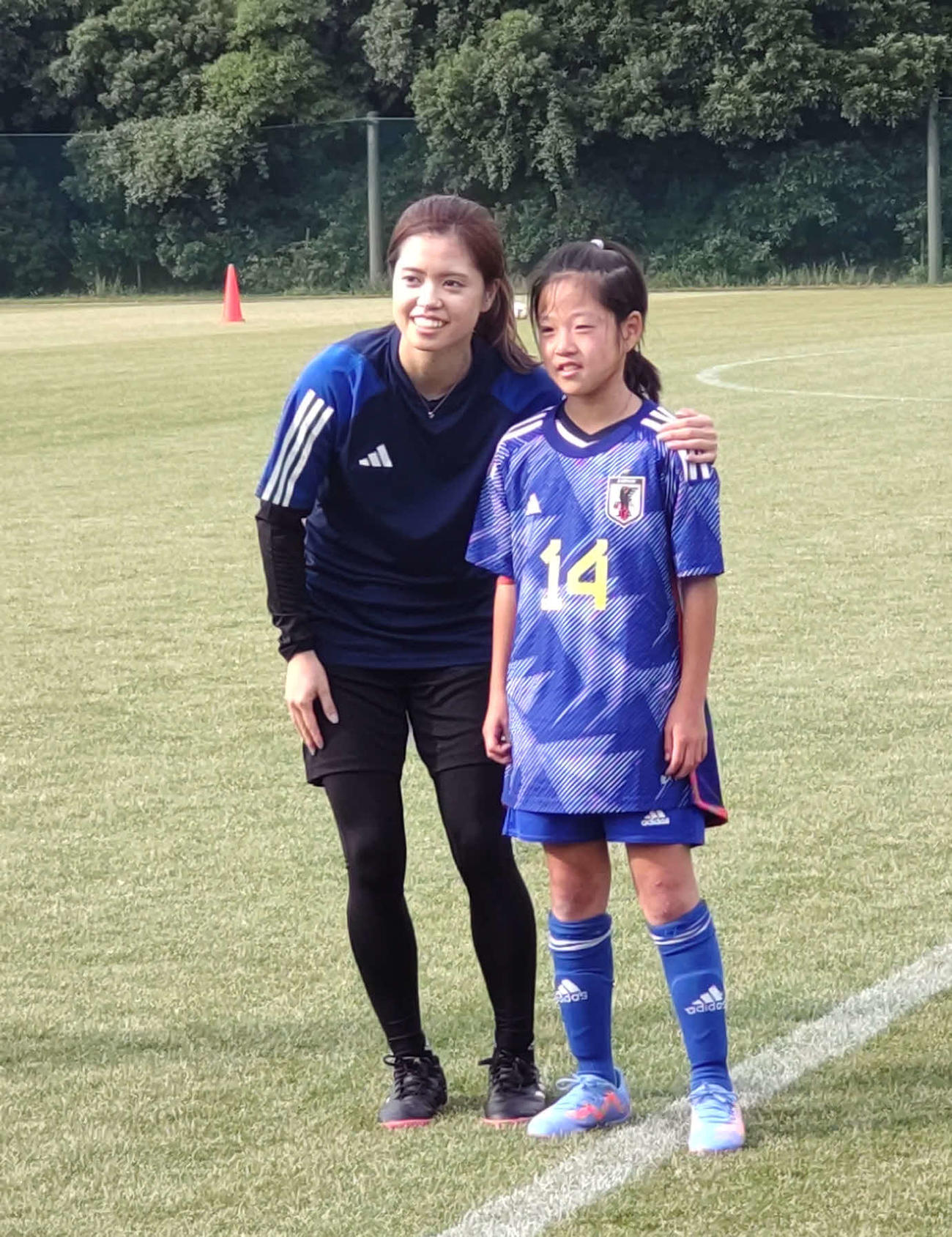 長谷川は、じゃんけん大会で優勝して同MFのサイン入りユニホームをゲットした少女と写真に写る
