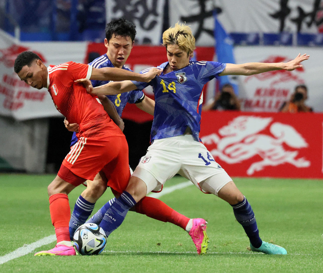 日本対ペルー　前半、ペルー選手とボールを奪い合う伊東（右）。奥は遠藤（撮影・加藤哉）