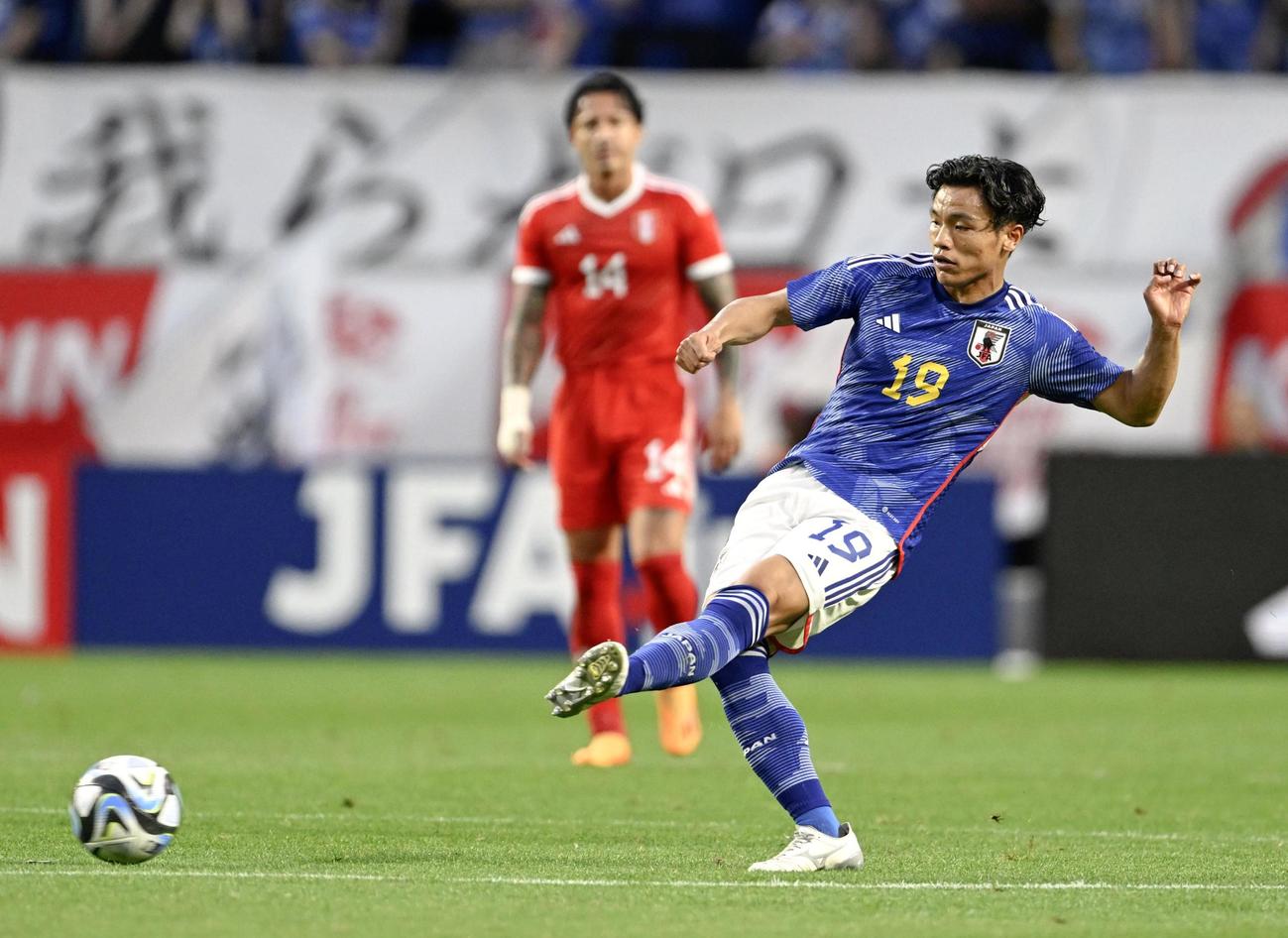日本―ペルー　前半、パスを出す旗手（右）（共同）